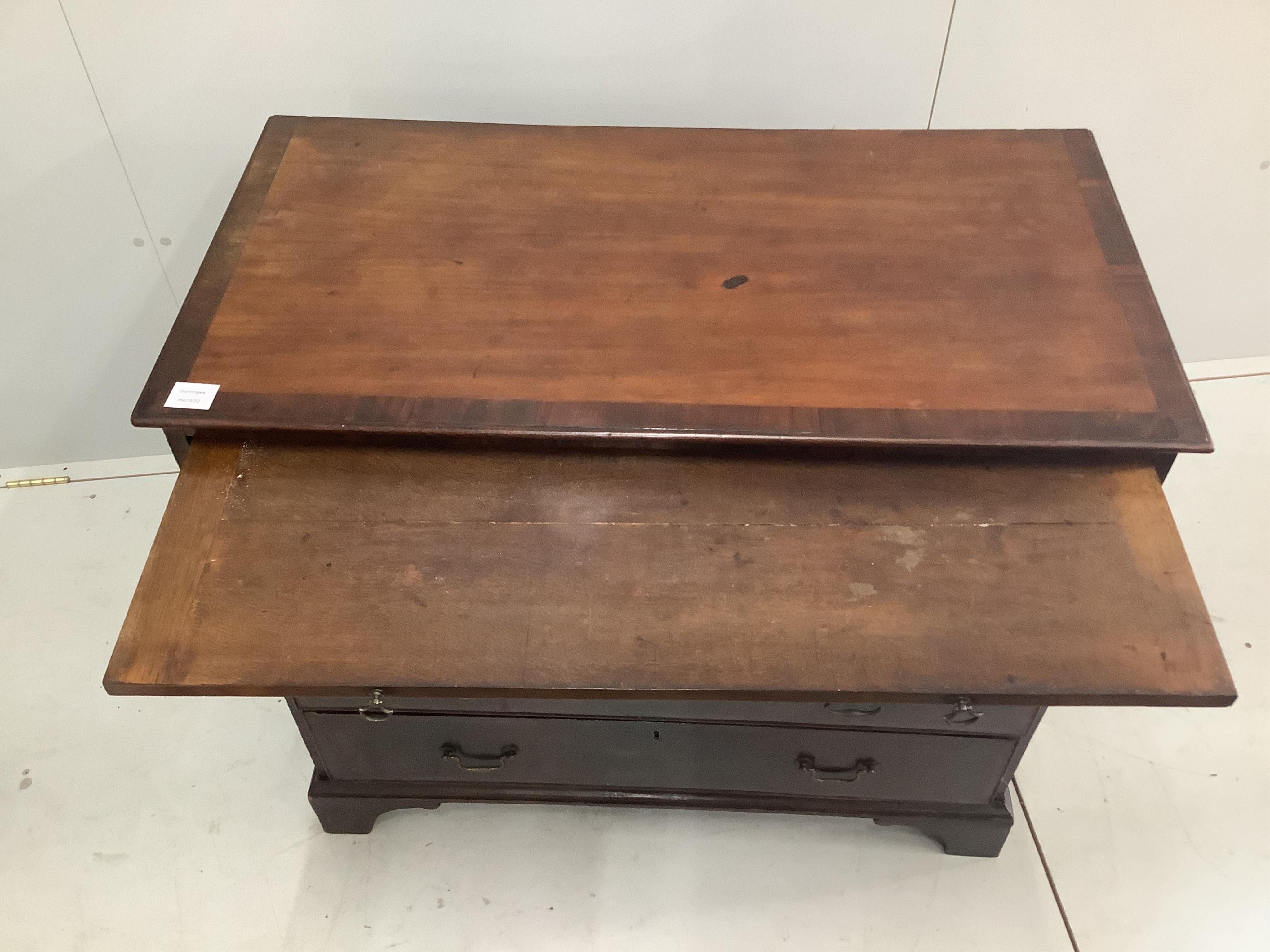 A small George III mahogany chest of four drawers with brushing slide, width 94cm, depth 49cm, height 84cm. Condition - fair